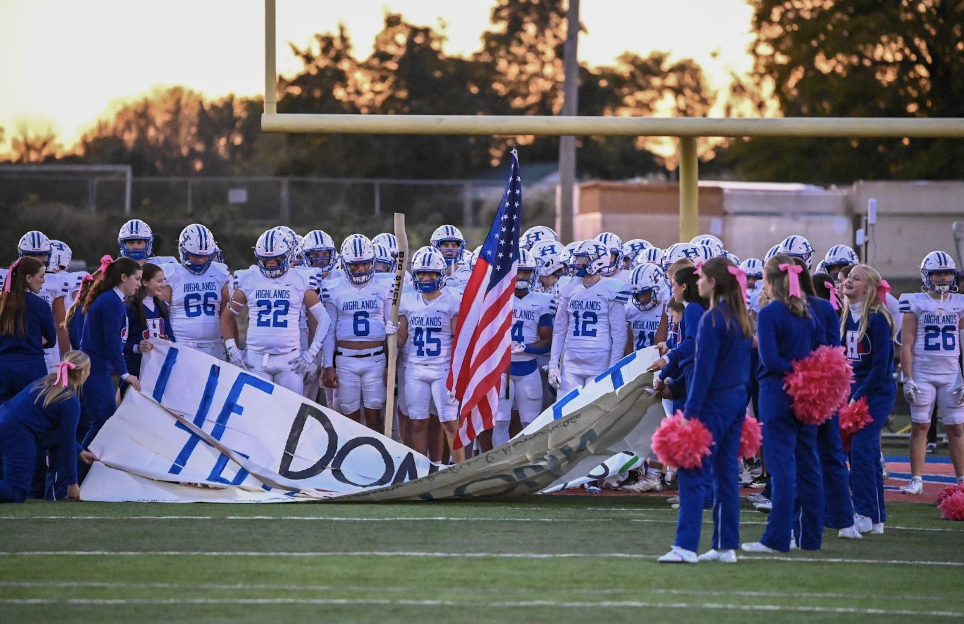 The football team prepares to run out on the field.
